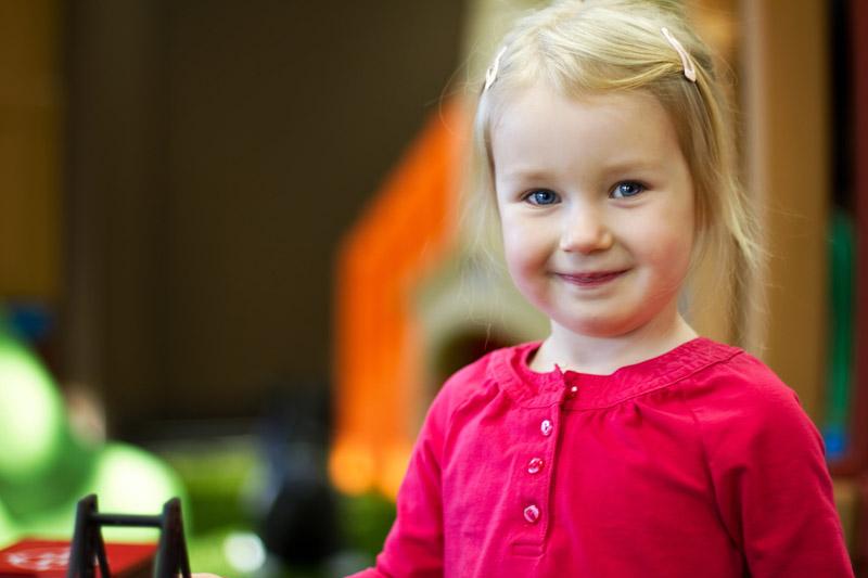 a little girl smiling while playing at Cafe O' Play